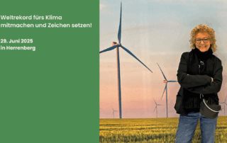 Beate Müller-Gemmeke steht vor einem stimmungsvollen Fotohintergrund mit Windrädern in einer grünen Landschaft bei Sonnenuntergang. Darüber der Schriftzug: „Weltrekord fürs Klima – mitmachen und Zeichen setzen! 29. Juni 2025 in Herrenberg“. Beate wirbt für den Aktionstag rund um das größte lebendige Windrad der Welt.